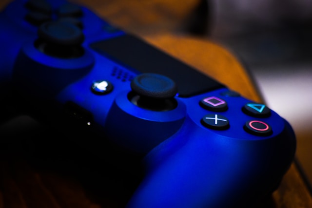 Refurbished PlayStation consoles collection banner featuring a close-up of a blue PlayStation DualShock 4 wireless controller with glowing blue LED lights.