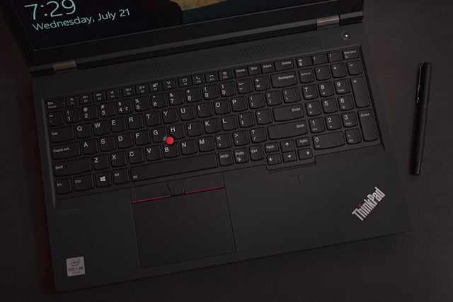 Refurbished Lenovo ThinkPad laptops collection banner showing a close-up overhead view of an open black ThinkPad laptop with its iconic red TrackPoint.