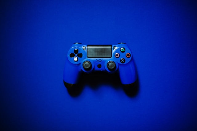 Best offer refurbished electronics collection banner featuring a blue PlayStation DualShock 4 wireless controller centered on a solid, vibrant blue background.