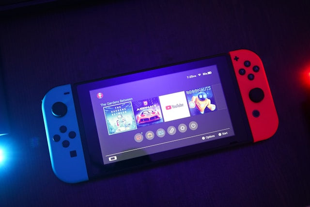 Refurbished Nintendo Switch consoles collection banner featuring a neon blue and neon red Nintendo Switch V2 handheld gaming console.