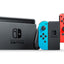 Nintendo Switch console with a black controller, blueJoy-Con, and redJoy-Con on a white background