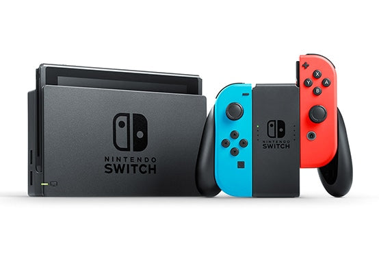Nintendo Switch console with a black controller, blueJoy-Con, and redJoy-Con on a white background